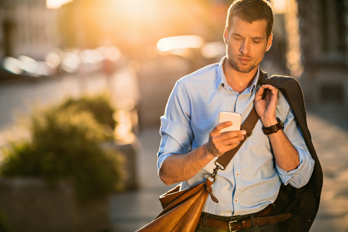 Photo-of-a-young-businessman-using-smart-phone-475967244_3869x2579.jpeg